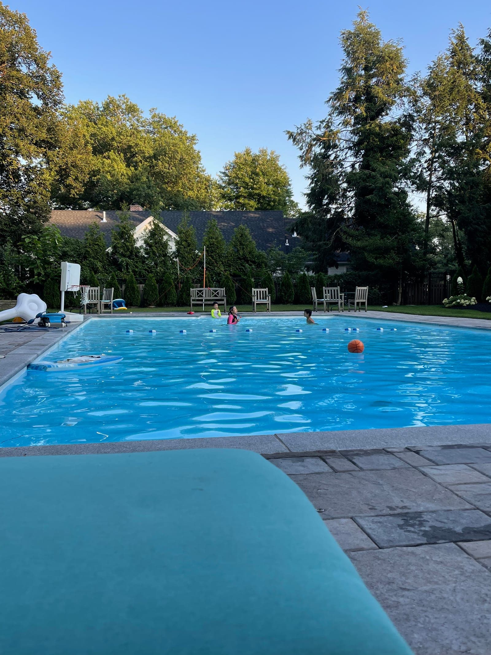 Natalie's big private backyard pool, surrounded by trees